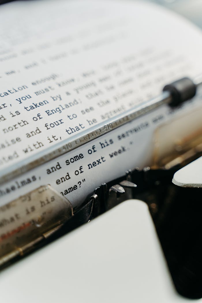 Detailed image of a typewriter with focus on typed text on paper, showcasing vintage technology.